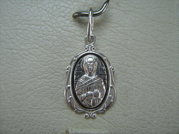 Solid 925 Sterling Silver small oval oxidized icon pendant and medal with prayer inscription to Saint Joanna Myrrhbearer decorated with filigree oval frame. Item number MD000698. On the display.