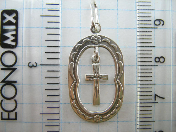 Solid 925 Sterling Silver cross pendant dangling in oval frame. Item number CR001173. Picture 4