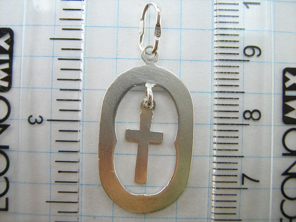 Solid 925 Sterling Silver cross pendant dangling in oval frame. Item number CR001173. Picture 7