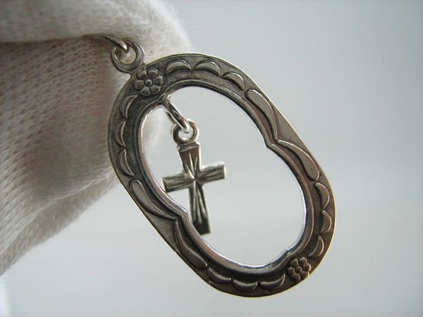 Solid 925 Sterling Silver cross pendant dangling in oval frame. Item number CR001173. Picture 12