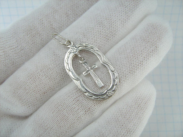 Solid 925 Sterling Silver cross pendant dangling in oval frame. Item number CR001173. Picture 2