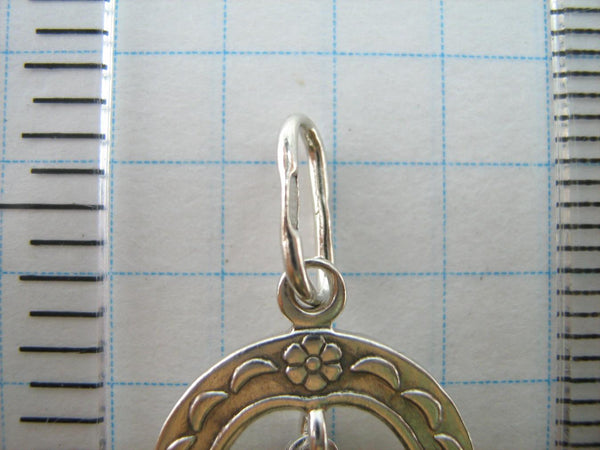 Solid 925 Sterling Silver cross pendant dangling in oval frame. Item number CR001173. Picture 5