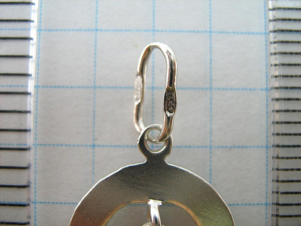 Solid 925 Sterling Silver cross pendant dangling in oval frame. Item number CR001173. Picture 8