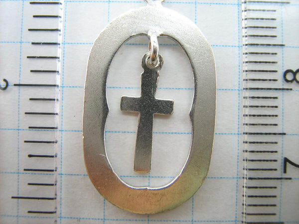 Solid 925 Sterling Silver cross pendant dangling in oval frame. Item number CR001173. Picture 9