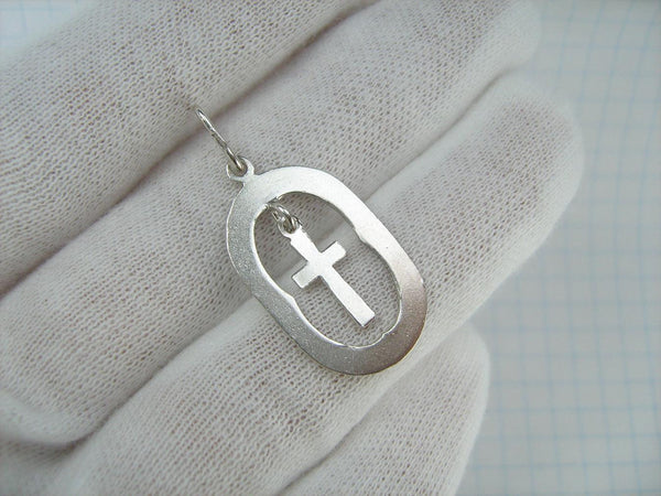 Solid 925 Sterling Silver cross pendant dangling in oval frame. Item number CR001173. Picture 3