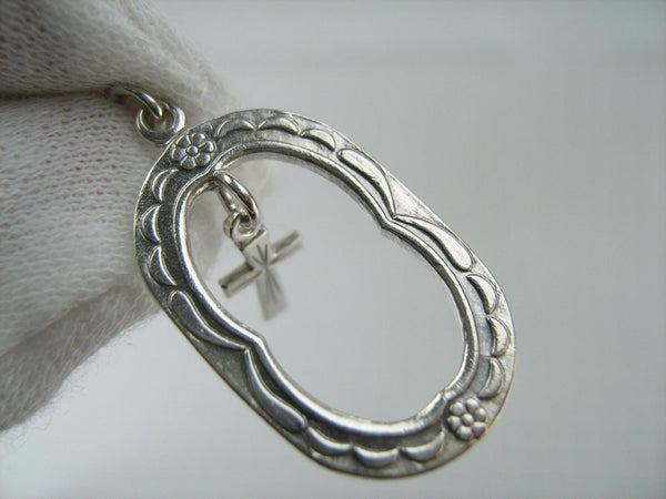 Solid 925 Sterling Silver cross pendant dangling in oval frame. Item number CR001173. Picture 11