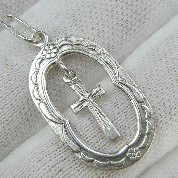 Solid 925 Sterling Silver cross pendant dangling in oval frame. Item number CR001173. Picture 1