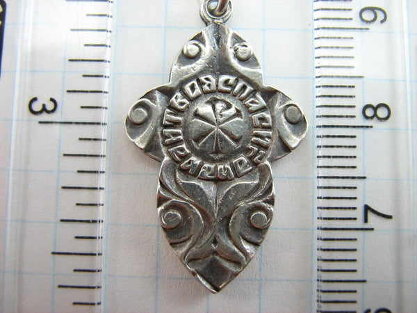 Vintage solid 875 Sterling cross pendant and crucifix with Christian prayer decorated with plant, floral and filigree pattern, depicting a Chi Rho symbol, also called chrismon or christogram.