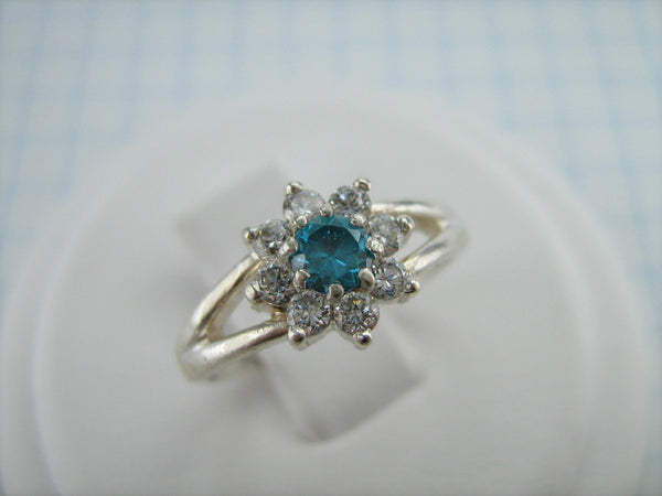 Pre-owned and estate 925 solid Sterling Silver cluster ring shaped flower or star and decorated with round white and blue Cubic Zirconia stone