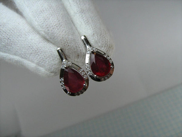 925 solid Sterling Silver earrings with real red ruby and latch back snap closure.