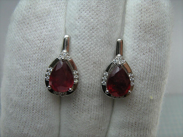 925 solid Sterling Silver earrings with real red ruby and latch back snap closure.