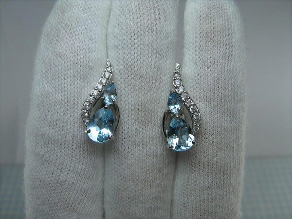 925 solid Sterling Silver earrings with genuine blue topaz and latch back snap closure.