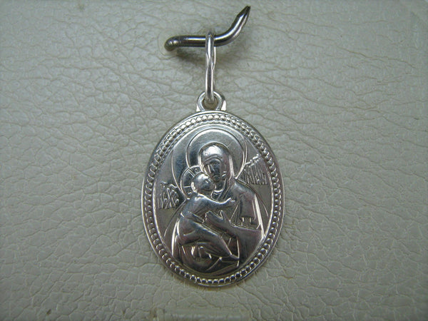 Real pure solid 925 Sterling Silver oval icon pendant and medal in frame depicting Mother of God Saint Mary blessed virgin holding Jesus Christ child that stands for Theotokos of Vladimir, also called Tenderness or Eleousa 