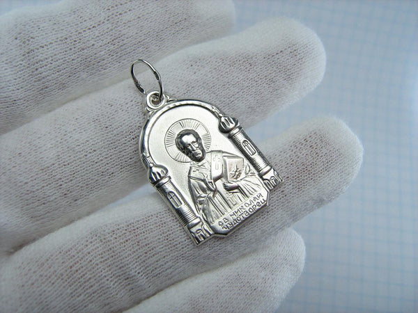 Vintage solid 925 Sterling Silver icon pendant and medal depicting Saint Nicholas the Wonderworker surrounded by church buildings with dome.