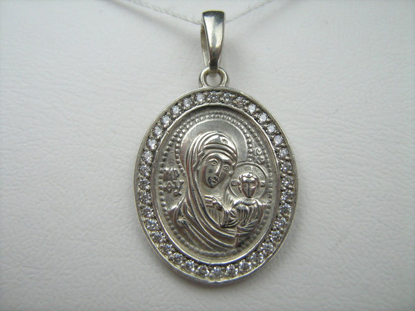 925 Sterling Silver pendant and medal of Kazan icon of Mother of God and Jesus Christ in the frame decorated with colorless stones.