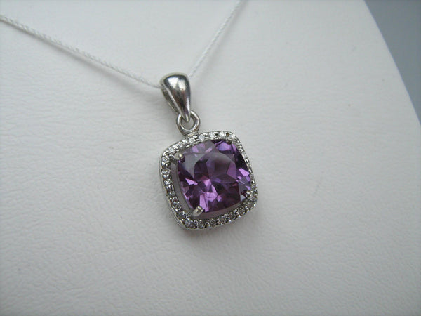 925 Sterling Silver small pendant with purple and red color change stone shaped surrounded by white Cubic Zirconia stones.