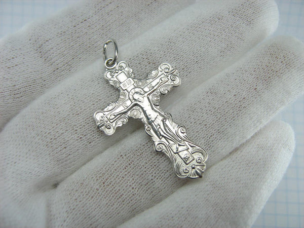 Silver cross pendant and crucifix with Christian blessing prayer.