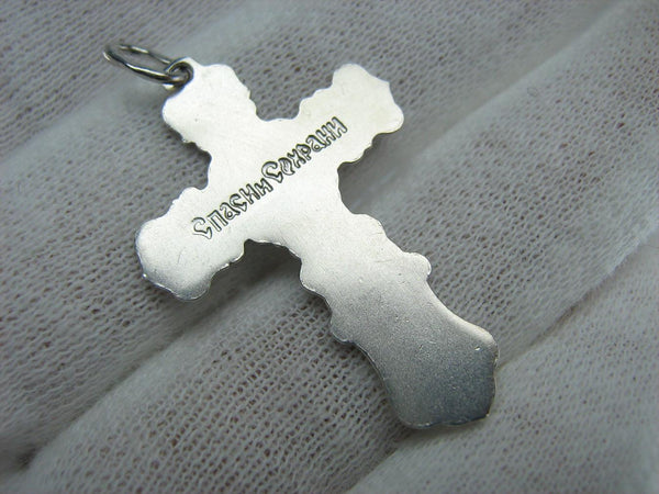 Silver cross pendant and crucifix with Christian blessing prayer.