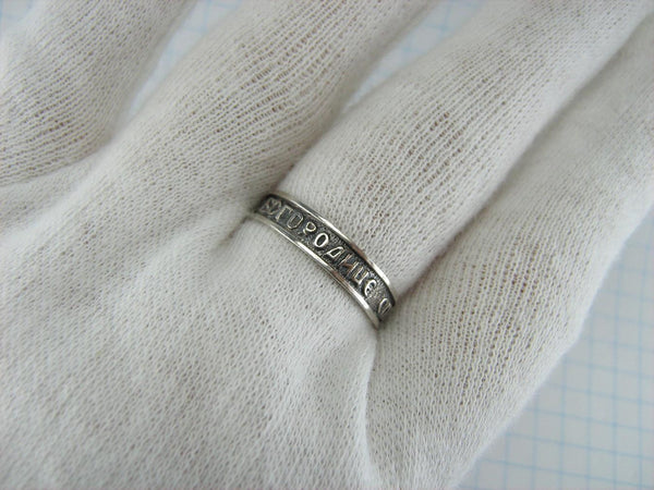 Vintage 925 Sterling Silver band with Christian prayer inscription to Mother of God on the oxidized background.
