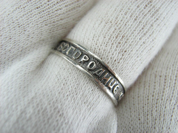 Vintage 925 Sterling Silver band with Christian prayer inscription to Mother of God on the oxidized background.