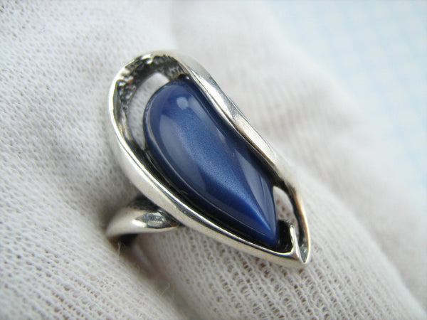 Estate silver ring with openwork finish and large deep blue cat’s eye stone cabochon.