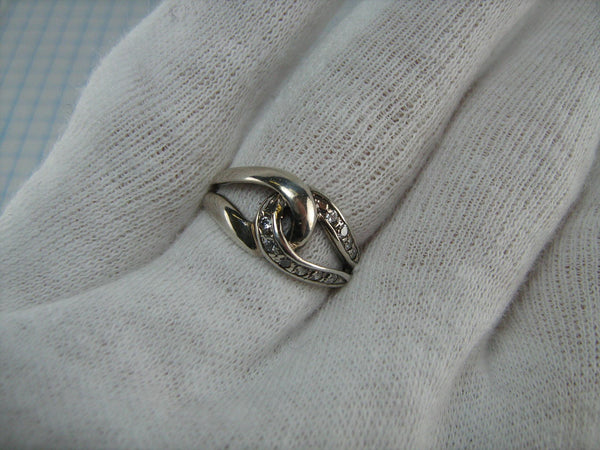 Pre-owned and estate 925 solid Sterling Silver ring depicting the sign of eternity or infinity decorated with round clear Cubic Zirconia stones
