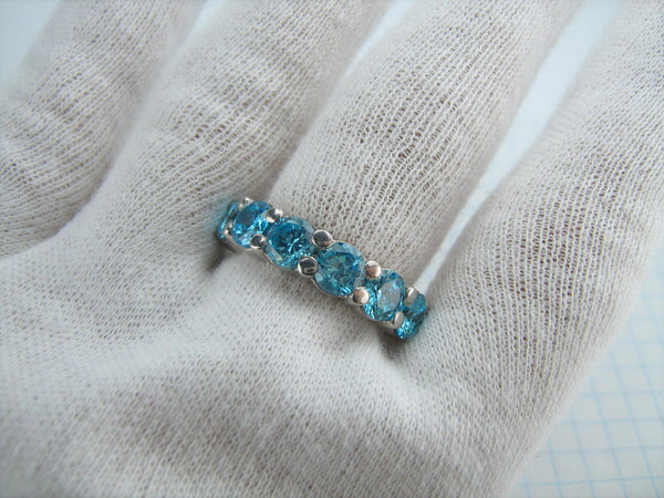 New and never worn 925 solid Sterling Silver cute ring and bright band decorated with 7 large round light blue Cubic Zirconia stones.