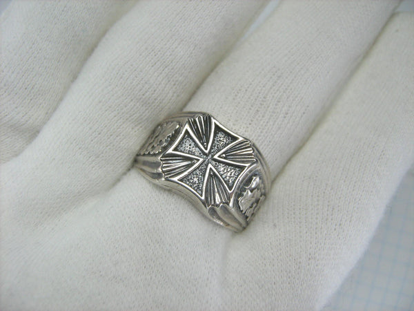 Solid 925 Sterling Silver signet ring decorated with maltese cross and oak leaves on the oxidized background.