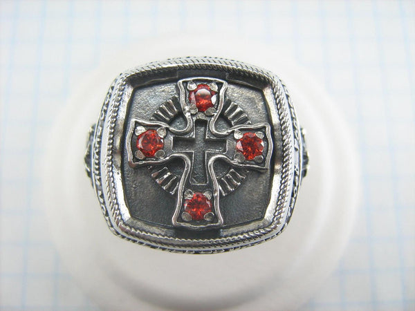 925 Sterling Silver heavy signet depicting Saint George fighting a dragon on the oxidized background with Christian prayer text and decorated with red Cubic Zirconia stones.