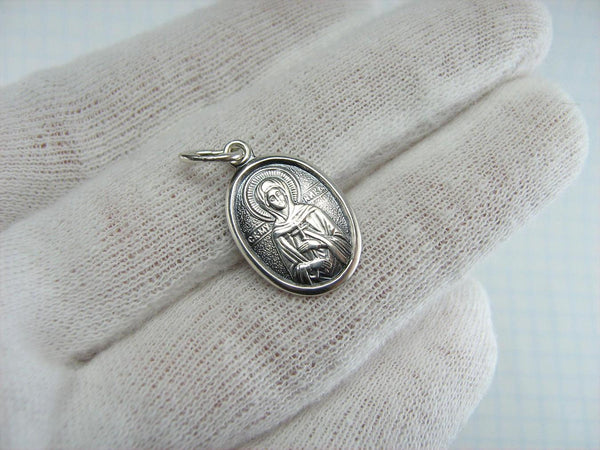 Solid 925 Sterling Silver small oval oxidized icon pendant and medal with prayer inscription to Saint Martyr Nika holding a Christian cross and decorated with oval frame and oxidized finish.