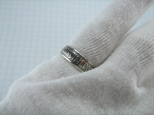 Silver religious band with Christian prayer inscription to God on the oxidized background with old believers cross.
