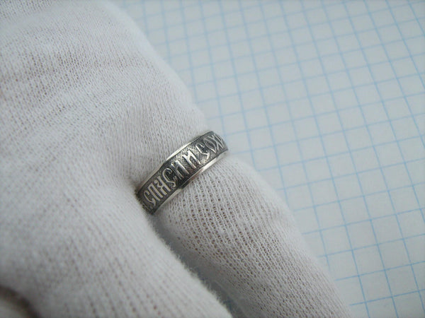 Silver religious band with Christian prayer inscription to God on the oxidized background with old believers cross.