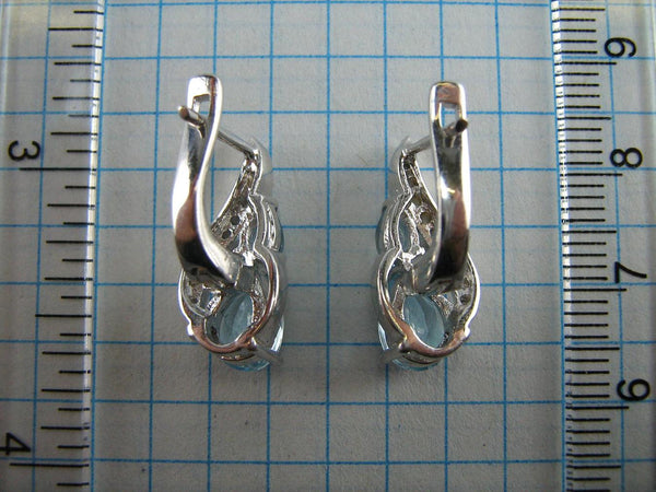925 solid Sterling Silver earrings with genuine blue topaz and latch back snap closure.