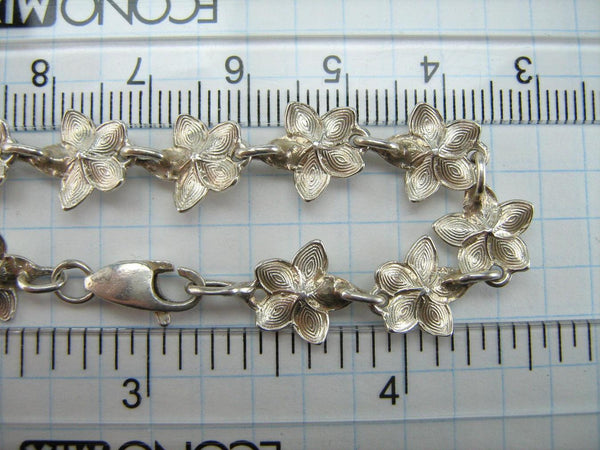 925 solid Sterling Silver bracelet with links shaped flowers decorated with round CZ stones.