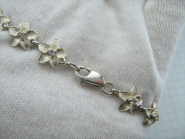925 solid Sterling Silver bracelet with links shaped flowers decorated with round CZ stones.