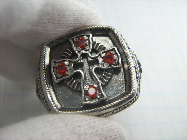 925 Sterling Silver heavy signet depicting Saint George fighting a dragon on the oxidized background with Christian prayer text and decorated with red Cubic Zirconia stones.