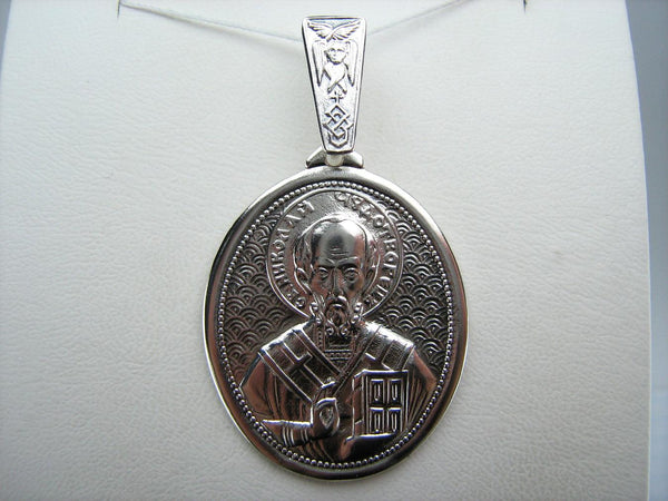 Vintage solid 925 Sterling Silver large icon pendant and medal depicting Saint Nicholas the Wonderworker decorated with images of cherubim, grapevine cross, fleur-de-lis, Celtic knot and prayer text.