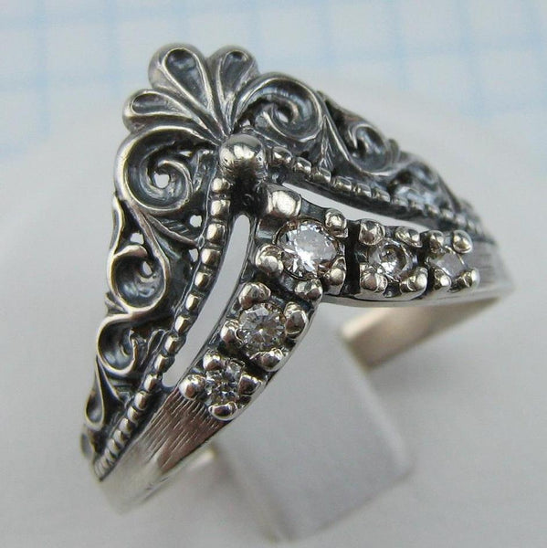 Pre-owned and estate 925 solid Sterling Silver ring shaped crown with openwork filigree pattern and five round clear Cubic Zirconia stones.