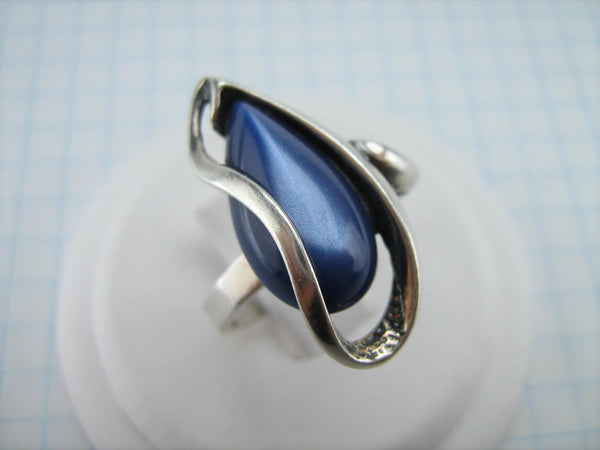 Estate silver ring with openwork finish and large deep blue cat’s eye stone cabochon.