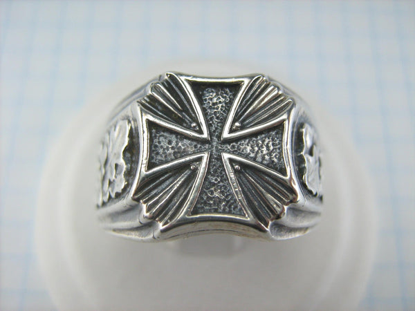Solid 925 Sterling Silver signet ring decorated with maltese cross and oak leaves on the oxidized background.